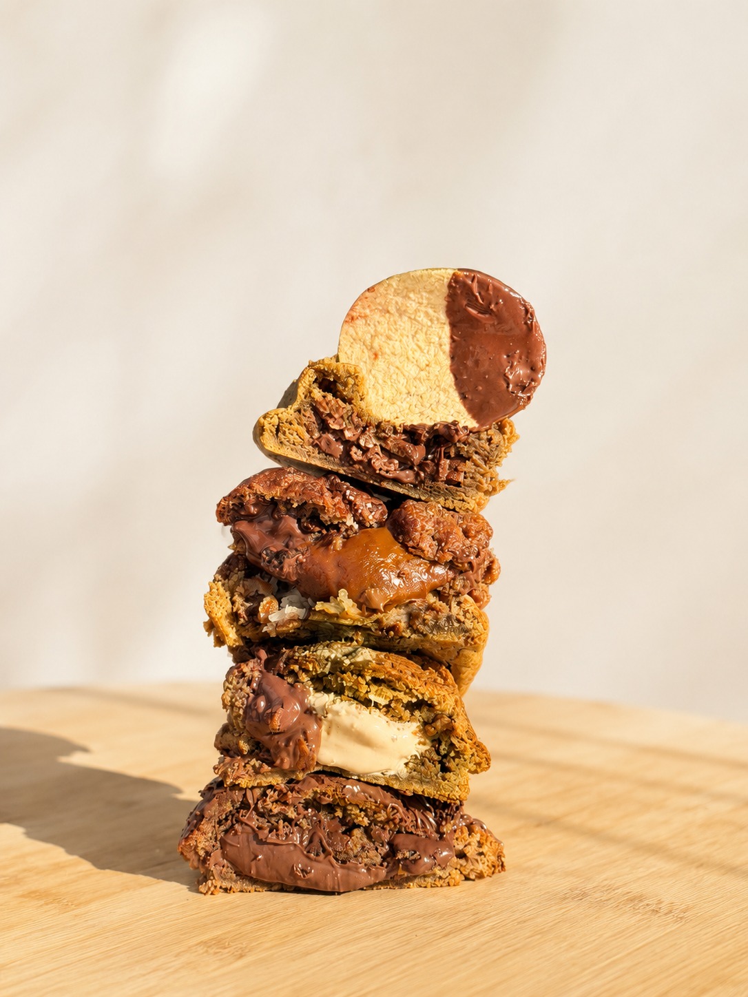 Torre de cinco cookies Fortiër empilhados, recheios de chocolate, doce de leite e coco à mostra